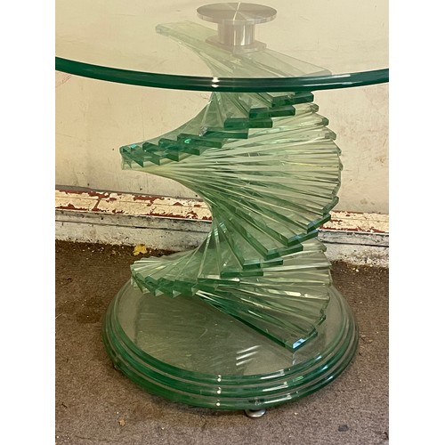 11 - A Contemporary Circular Glass Toped Low Table On A Stepped Spiral Base. 60 x 51 cms