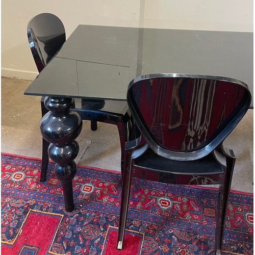 44 - Black Glass Top Table  And Four Plastic Chairs.