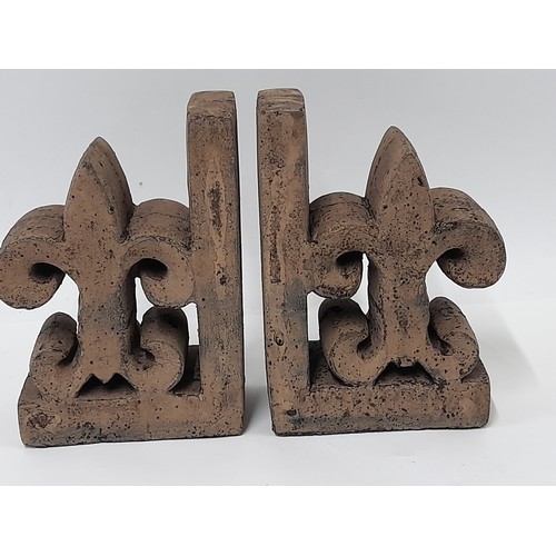 493 - Pair of Terracotta coloured Book ends Fluer De Lis each measuring 13cm x 19cm x 8cm