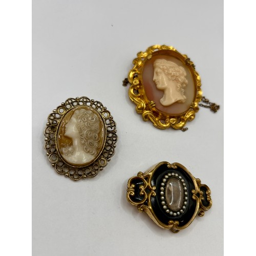 111 - Two Gold Coloured Cameo Brooches Along With Two Decorative Gem Set Brooches, Largest 5cm x 4cm.  (4)