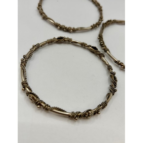 115A - Three Sterling Silver Decorative Hoop Bracelets. 8cm. Total 38.42Grams.  (3)