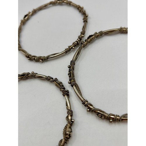 115A - Three Sterling Silver Decorative Hoop Bracelets. 8cm. Total 38.42Grams.  (3)