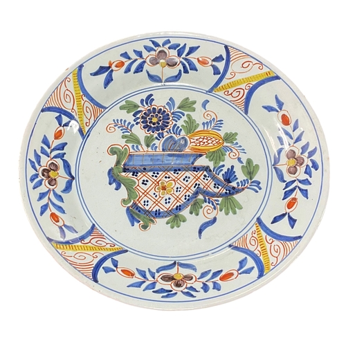 277 - 18th-century Delft polychrome plate featuring a central floral scene With Mark to verso.  23.5cm Dia... 