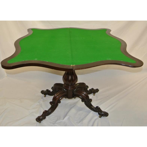 86 - Georgian rosewood card table with serpentine bordered fold-over top, on reeded baluster shaped colum... 