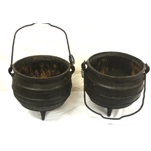 128 - Pair of cast iron skillet pots with shaped handles