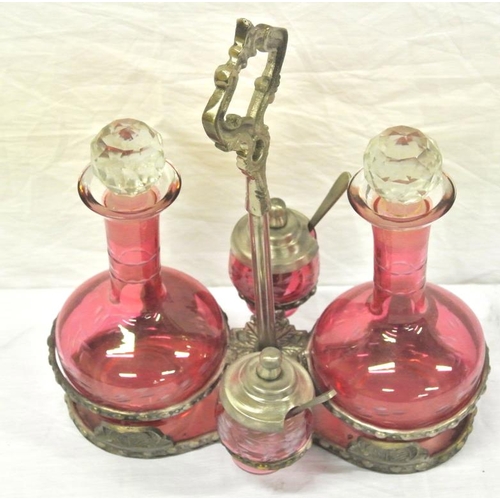 113 - Cranberry glass condiment set on silver plated stand with shaped legs