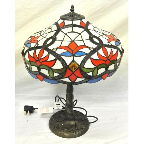 57 - Tiffany style electric table lamp with multi-coloured shade on twist decorated stand with circular b... 