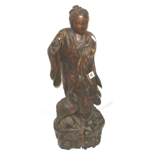 42 - Carved figure of an Oriental monk on shaped base