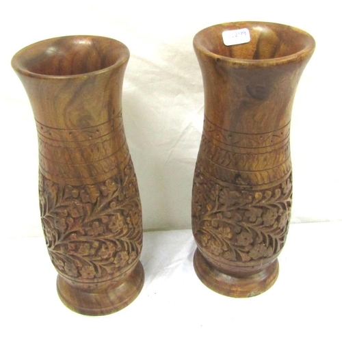 68 - Pair of Oriental carved teak baluster shaped vases with ornate foliate carving on circular bases