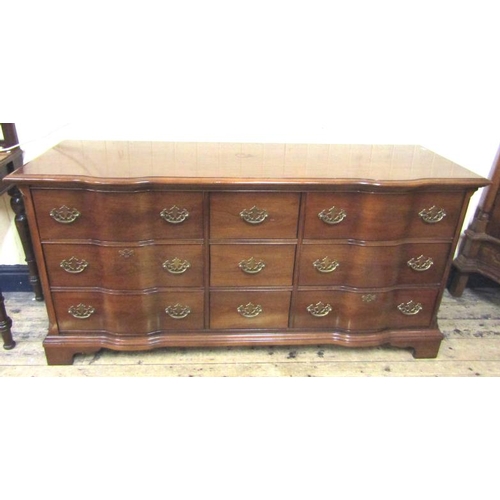 20 - Serpentine shaped sideboard with six side and three central drawers all with ornate brass drop handl... 