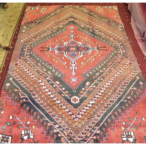 41 - Red ground Persian Qashqai tribal rug of traditional design. 220 x 130cm