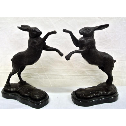53 - Pair of bronzed ornaments of hares on shaped marble bases