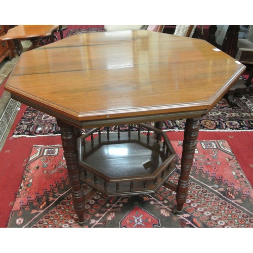 50 - Edwardian hexagonal shaped occasional or centre table raised on ring-turned shaped legs with castors