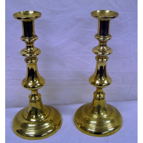 17 - Pair of brass candlesticks of baluster form with circular bases