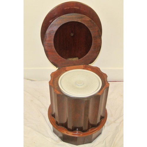 36 - Victorian mahogany commode with circular lift-up lid, fitted interior, wavy border, on round plinth