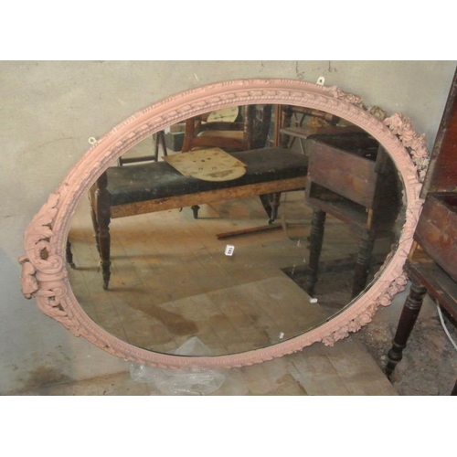 143 - Regency style oval wall mirror with ornate foliate, scroll and ribbon decoration