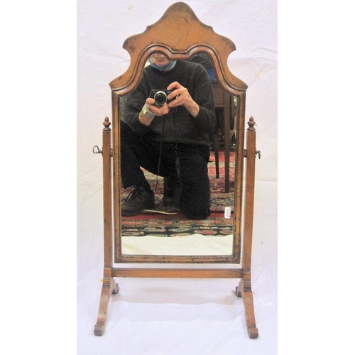 17 - Victorian walnut framed swivel mirror with shaped top, tapering columns, on bracket feet