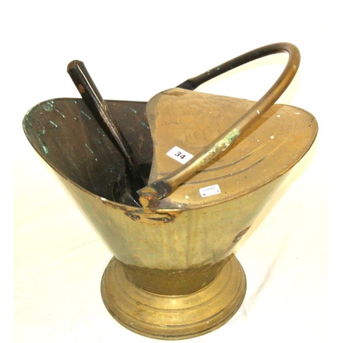 42 - Edwardian brass helmet shaped fuel bucket with shaped handle and foliate decoration