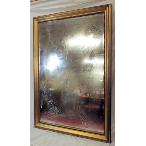 41 - Large bevelled glass gilt framed wall mirror with beaded decoration