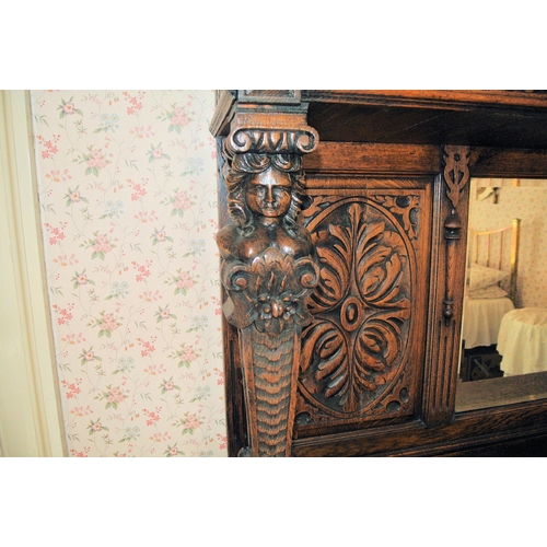 106 - Jacobean oak sideboard with ornate scroll and foliate carving, shaped columns, with figured mounts, ... 