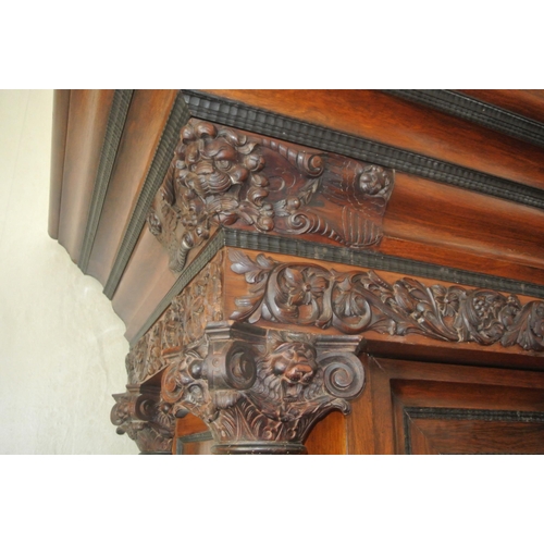 150 - Large French cabinet with foliate and cherub carved decoration, and columns, shelved interior, two d... 