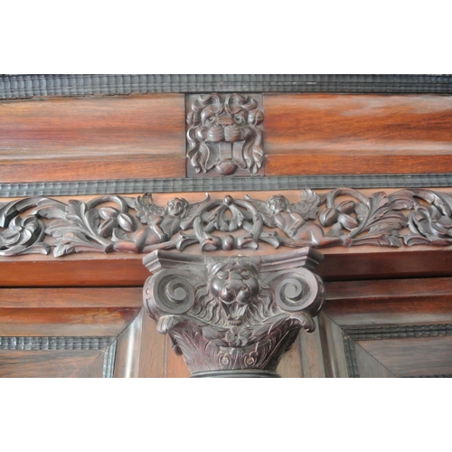 150 - Large French cabinet with foliate and cherub carved decoration, and columns, shelved interior, two d... 