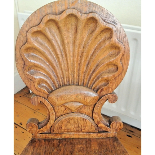 241 - Pair of Victorian oak hall chairs with shell and scroll backs, serpentine fronted seats, on reeded t... 