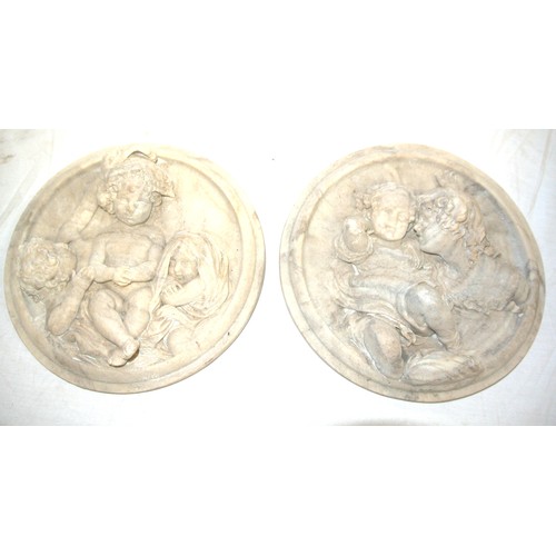 233 - Pair of round marbled plaques decorated with children in relief