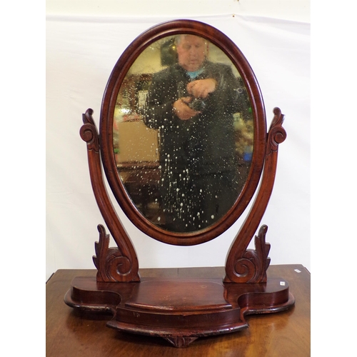 131 - Victorian mahogany framed oval swivel mirror with scroll decorated columns, on shaped base