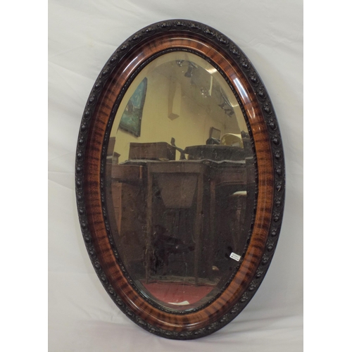 139 - Victorian style oval bevelled glass wall mirror in ornate rosewood frame