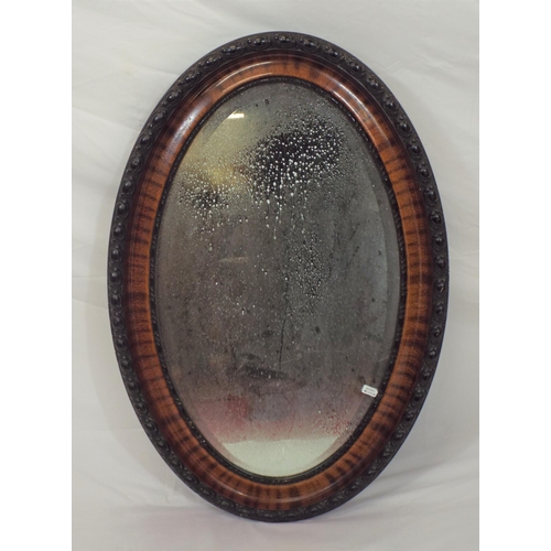 139 - Victorian style oval bevelled glass wall mirror in ornate rosewood frame