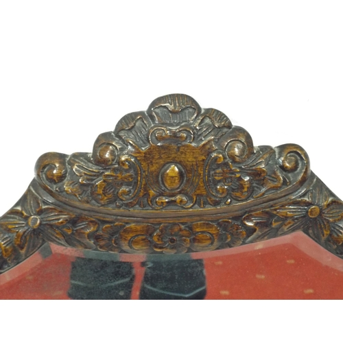 157 - Ornate shaped bevelled glass wall mirror with ornate foliate and grapevine decorated frame