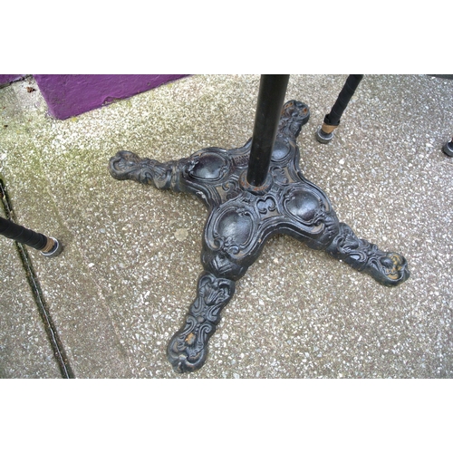 211 - Square topped mahogany table with rounded borders, on metal column with ornate cast iron foliate dec... 