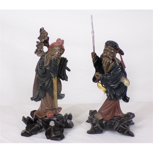 227 - Pair of Asian figures of gentlemen, on shaped bases