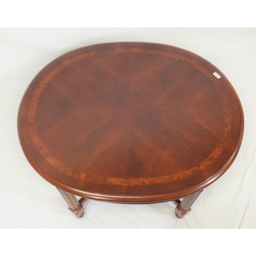 29 - Oval inlaid occasional table with brass mounts, reeded columns and stretchers