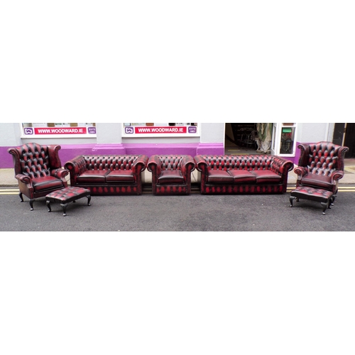 350 - 7 piece lounge suite with red leather button back upholstery, brass pins, 2 wingback armchairs, 3 se... 