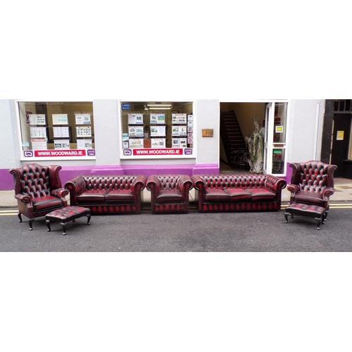 350 - 7 piece lounge suite with red leather button back upholstery, brass pins, 2 wingback armchairs, 3 se... 