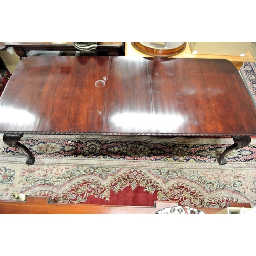 40 - Oblong mahogany dining table with extra leaf, carved border, on carved cabriole legs with claw on ba... 