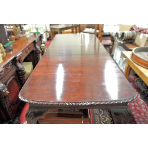 40 - Oblong mahogany dining table with extra leaf, carved border, on carved cabriole legs with claw on ba... 