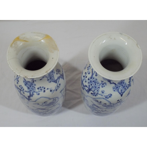 43 - Pair of Asian baluster shaped flower vases with blue and white foliate and bird decoration