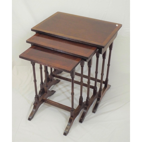 44 - Nest of three Edwardian inlaid mahogany tables with reeded borders, spindle columns, on bracket feet