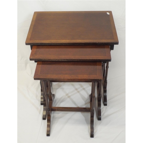 44 - Nest of three Edwardian inlaid mahogany tables with reeded borders, spindle columns, on bracket feet