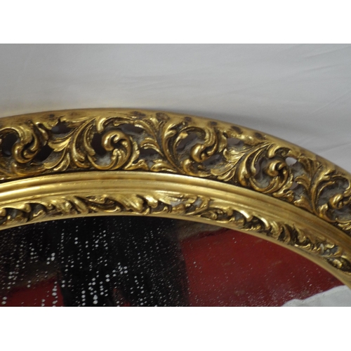 57 - Round gilt framed wall mirror with ornate foliate decoration