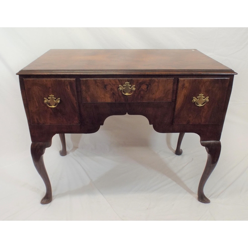 69 - Queen Anne walnut lowboy with central drawer, two side drawers, brass drop handles with shaped backp... 