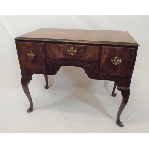 69 - Queen Anne walnut lowboy with central drawer, two side drawers, brass drop handles with shaped backp... 