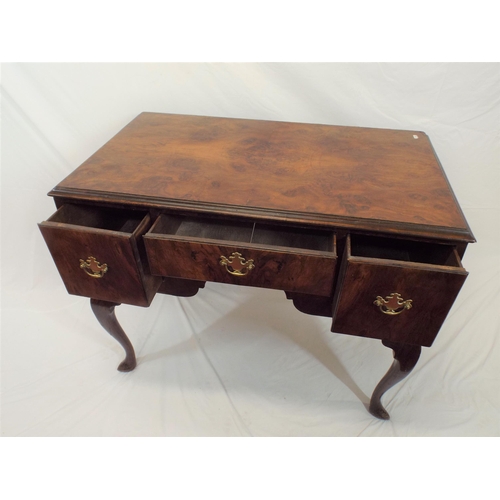 69 - Queen Anne walnut lowboy with central drawer, two side drawers, brass drop handles with shaped backp... 