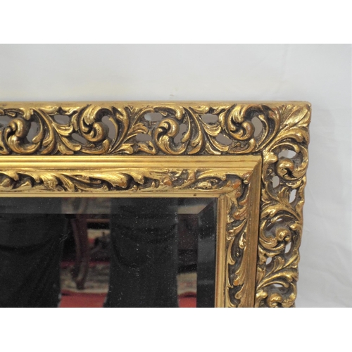 76 - Large gilt framed bevelled glass mirror with ornate foliate decorated frame