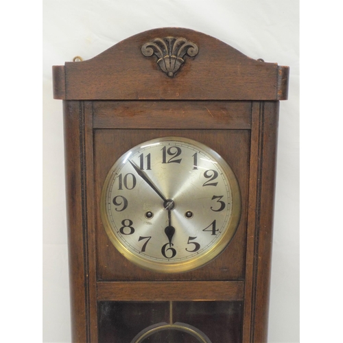 83 - Oak case wall clock with round brass framed silvered dial and pendulum, and bevelled glass insets