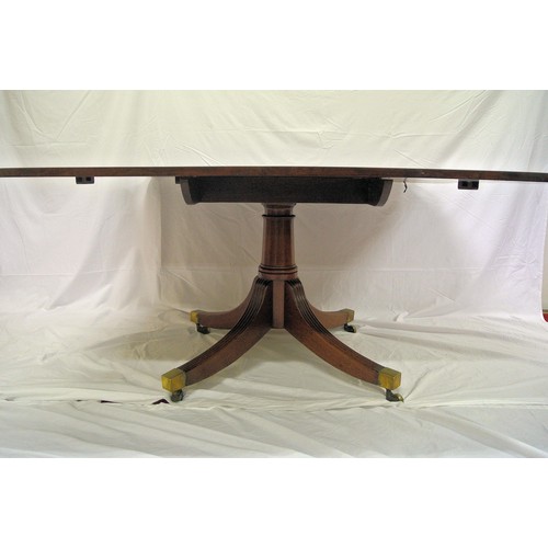 100 - Georgian mahogany library or dining table with tip-up top, rounded corners, raised on turned taperin... 