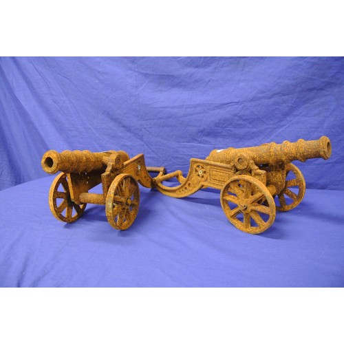 213 - Pair of cast iron model cannons on wheeled carriages